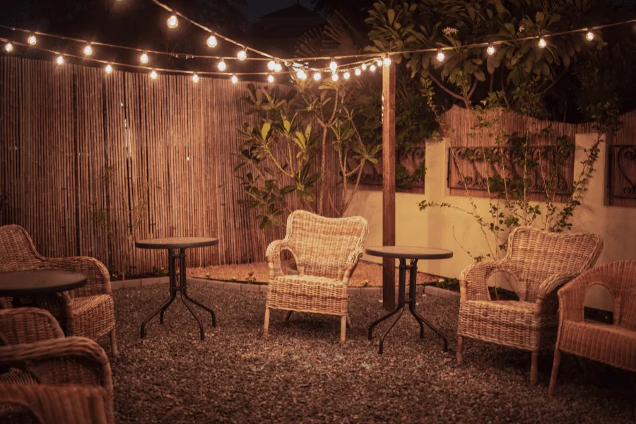 String Lights with Chairs and a Table in a Backyard